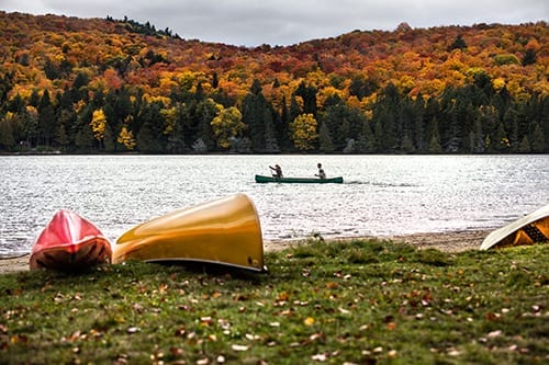 Couple enjoying a ride on a typical canoe in the Algonquin Park, Ontario - Canada.