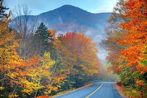 Autumn colors along the Kancamagus Highway in the White Mountains of New Hampshire. Photo taken on a misty morning during the peak fall foliage season. New Hampshire is one of New England's most popular fall foliage destinations bringing out some of the best foliage in the United States