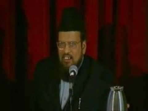 man sitting speaking at microphone